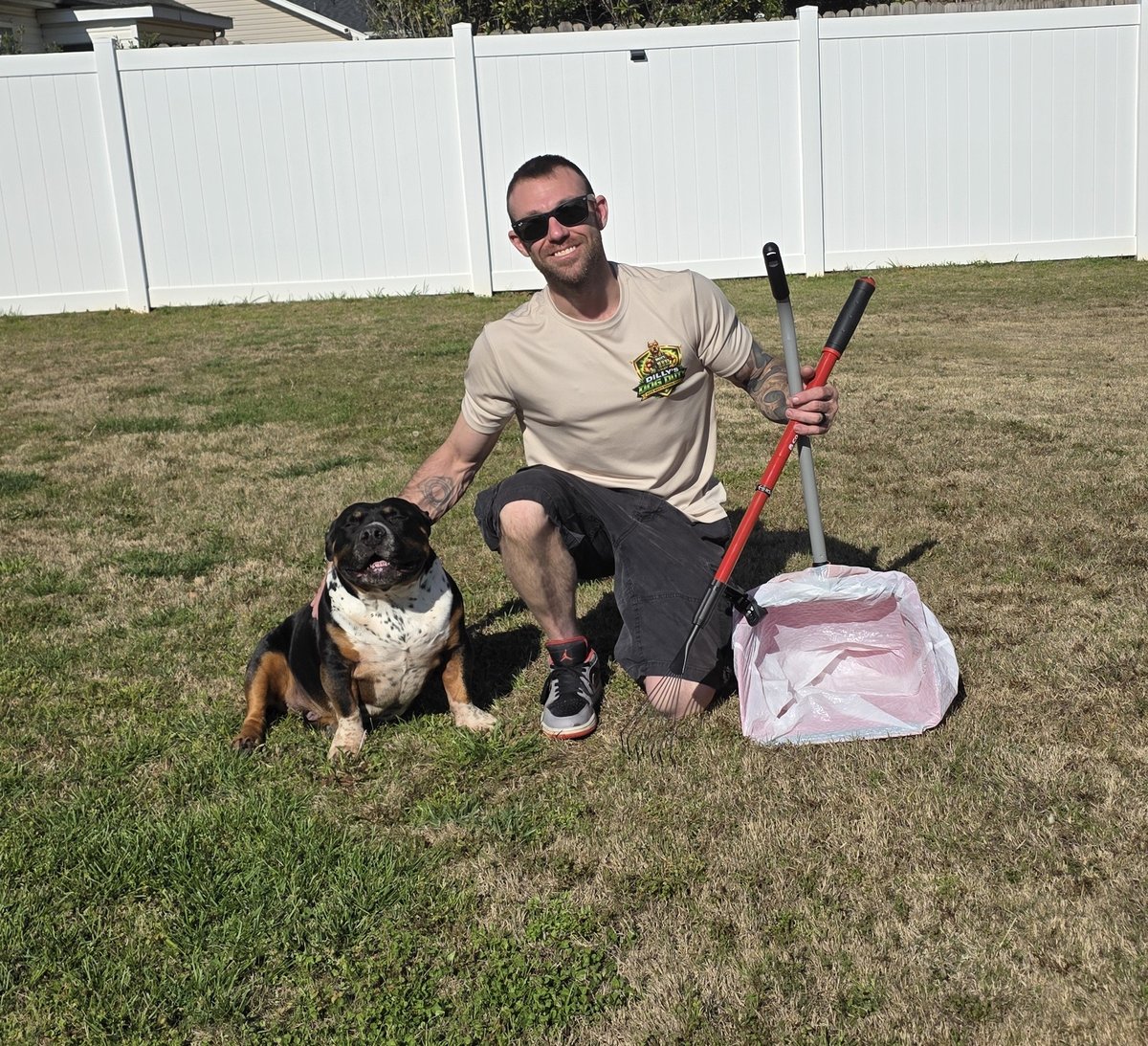 Dilly's Dog Duty technician removing dog waste from yard in Greenville SC
